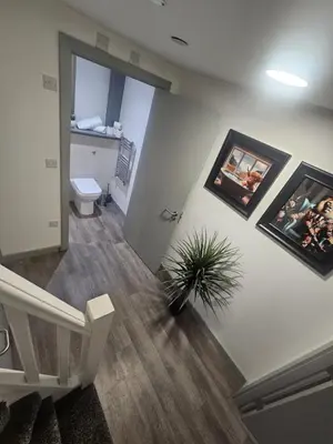 a hallway with a toilet and a potted plant at Modern Duplex Apartment - Liverpool City Centre in Liverpool