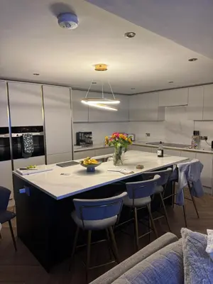 a kitchen with a large island with blue bar stools at 6 bed detached house Formby Royal Birkdale The Open 2026 in Formby