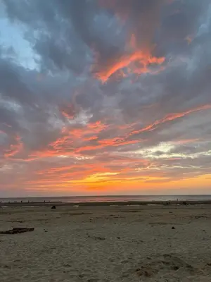a sunset on a beach with a cloudy sky at 6 bed detached house Formby Royal Birkdale The Open 2026 in Formby