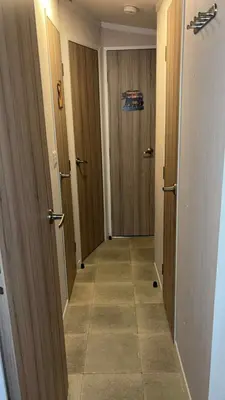 a hallway with two doors and a tile floor at B10 - The Escape Pod in Heysham