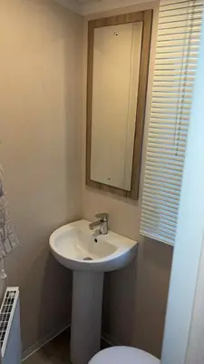 a bathroom with a sink and a mirror and a toilet at B10 - The Escape Pod in Heysham