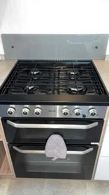 a black stove top oven in a kitchen at B10 - The Escape Pod in Heysham