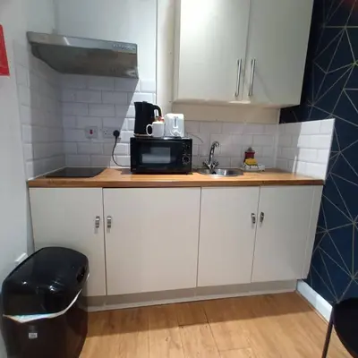 a small kitchen with a sink and a microwave at Bold Street Studio V in Liverpool