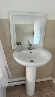a white sink in a bathroom with a mirror at Anfield Stay Free Parking 5 minute walk in Liverpool