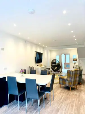 a large living room with a table and chairs at Mode Apartments St Annes in Lytham St Annes