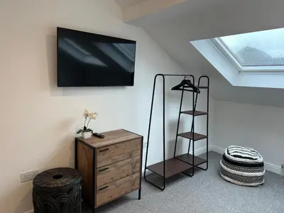 a room with a flat screen tv on a wall at Mode Apartments St Annes in Lytham St Annes