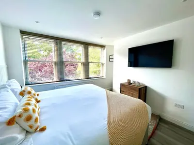 a bedroom with a teddy bear sitting on a bed at Mode Apartments St Annes in Lytham St Annes