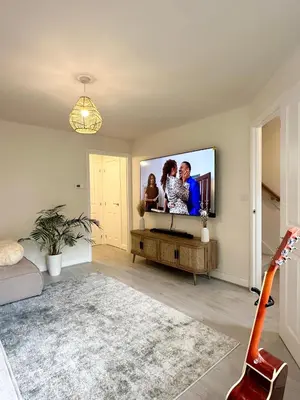 a living room with a flat screen tv on a wall at Charming 1 Bedroom with Private Bath in Woodplumpton