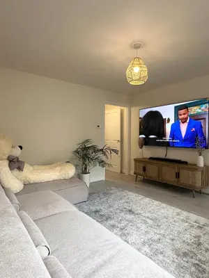 a living room with a couch and a flat screen tv at Charming 1 Bedroom with Private Bath in Woodplumpton
