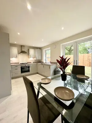 a kitchen with a dining table with chairs and a tableasteryasteryasteryasteryastery at Charming 1 Bedroom with Private Bath in Woodplumpton