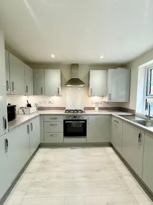 a kitchen with white cabinets and a stove top oven at Charming 1 Bedroom with Private Bath in Woodplumpton