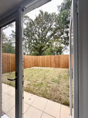 an open door to a yard with a fence at Charming 1 Bedroom with Private Bath in Woodplumpton