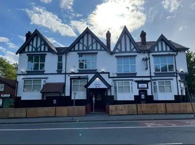 a black and white building on the side of a street at The Prince Alfred Rooms in Liverpool