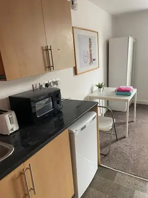 a kitchen with a counter top with a microwave at Babo accommodation in Bolton