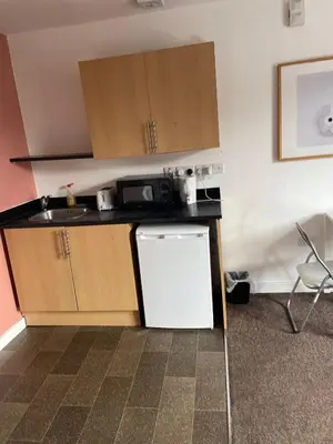 a small kitchen with a sink and a refrigerator at Babo accommodation in Bolton