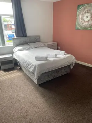 a bedroom with a bed with towels on it at Babo accommodation in Bolton