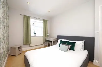 a bedroom with a large white bed and a window at 2 Bed Flat in Ulverston in Ulverston