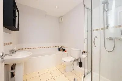 a bathroom with a toilet and a sink and a shower at 2 Bed Flat in Ulverston in Ulverston