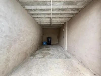 an empty hallway of a building with a trash can at 2 Bed Flat in Ulverston in Ulverston