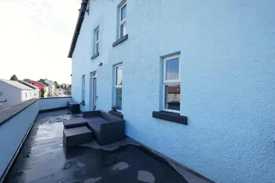 a blue building with benches on the side of it at 2 Bed Flat in Ulverston in Ulverston