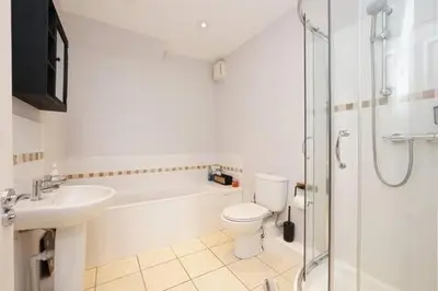 a bathroom with a sink and a toilet and a shower at 2 Bed Flat in Ulverston in Ulverston