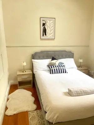a bedroom with a large bed with two night stands at Valentinez Properties - Apart Hotel with a garden in Liverpool in Liverpool