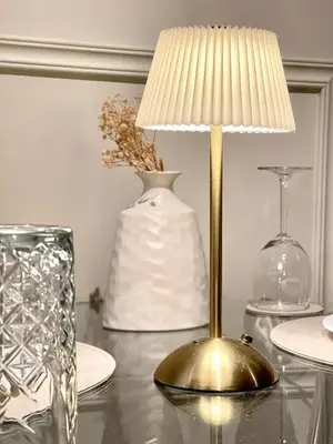 a table with a gold lamp and a vase at Valentinez Properties - Apart Hotel with a garden in Liverpool in Liverpool