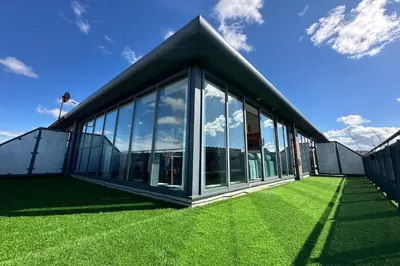 a building with large windows on a green lawn at City Centre Penthouse on Concert Square with City Views in Liverpool