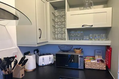 a kitchen with a counter top with a microwave at City Centre Penthouse on Concert Square with City Views in Liverpool