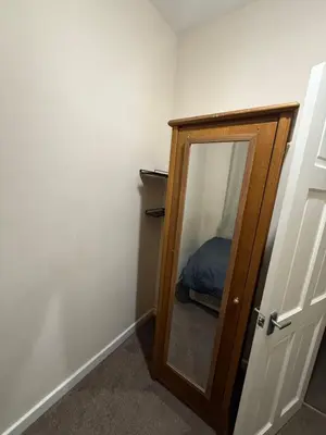 a bedroom with a mirror and a bed in a room at Room Near Anfield - Walk to the Stadium in Liverpool