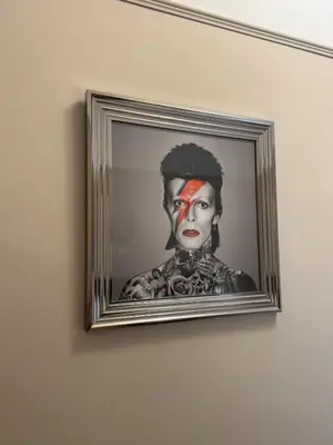 a painting of a woman with red paint on her face at The Links House Lytham St Annes in Lytham St Annes