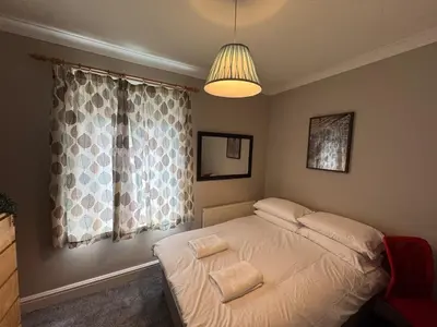 a bedroom with a bed with two towels on it at The Links House Lytham St Annes in Lytham St Annes