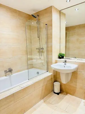 a bathroom with a tub and a sink and a shower at City Centre Free Parking 2 Bedroom Apartment in Liverpool