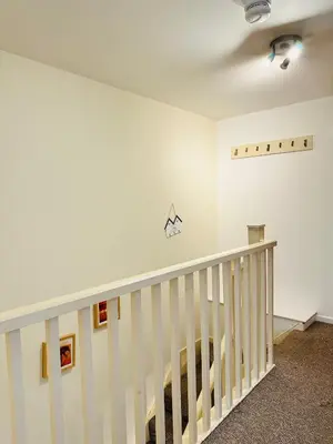 a staircase in a room with white walls at City Centre Free Parking 2 Bedroom Apartment in Liverpool