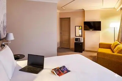 a hotel room with a bed with a laptop on it at Atlantic Tower Liverpool City Center By Dancenter in Liverpool