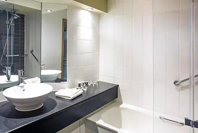 a bathroom with a sink and a toilet and a shower at Atlantic Tower Liverpool City Center By Dancenter in Liverpool