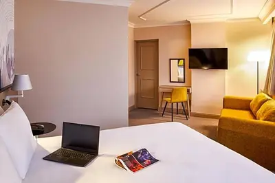 a hotel room with a bed with a laptop on it at Atlantic Tower Liverpool City Center By Dancenter in Liverpool