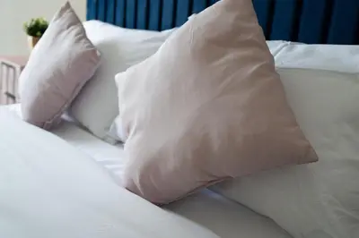 a white bed with white pillows on it at Mersey View 4 Bedroom by Liverpoollux Next To Everton Stadium in Liverpool