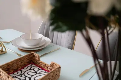 a table with a cup and a plate on a table at Mersey View 4 Bedroom by Liverpoollux Next To Everton Stadium in Liverpool
