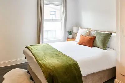 a bedroom with a white bed with pillows and a window at Host & Stay - Bishop House in Liverpool