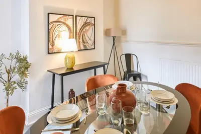 a dining room with a glass table and chairs at Host & Stay - Bishop House in Liverpool