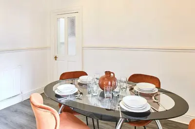 a dining room with a table with chairs and a vase at Host & Stay - Bishop House in Liverpool