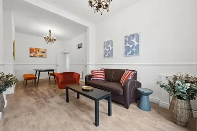a living room with a couch and a table at Anfield Cozy House in Liverpool