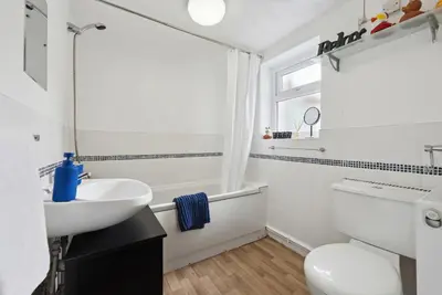 a white bathroom with a sink and a toilet at Anfield Cozy House in Liverpool
