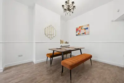 a dining room with a table and two chairs at Anfield Cozy House in Liverpool