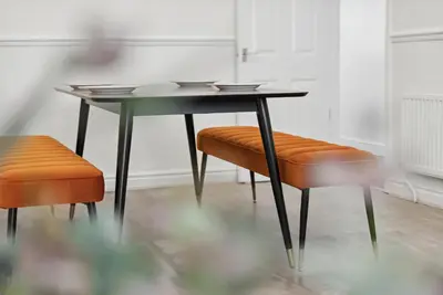a table and two chairs and a table and stool at Anfield Cozy House in Liverpool