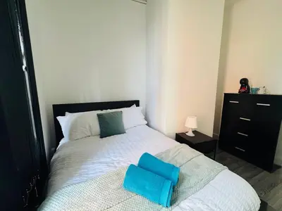 a bedroom with a bed with two pillows on it at Pembroke Place Private Room 2B in Liverpool
