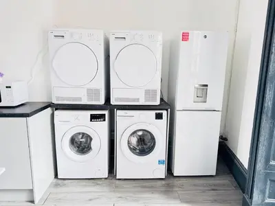 four washers and dryers in a laundry room at Pembroke Place Private Room 2B in Liverpool
