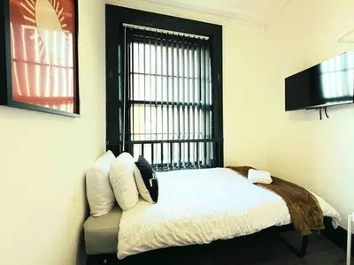 a bedroom with a bed with a window and a television at Pembroke Place Private Room 5B in Liverpool