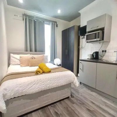 a bedroom with a bed with a yellow towel on it at Bold Street Studio III in Liverpool